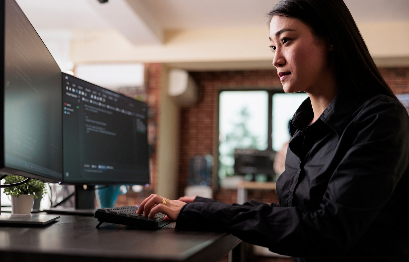 A female typing on a computer while working on a projec