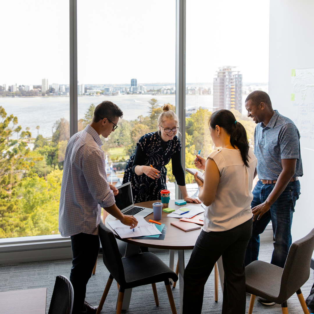 Team of professionals standing and collaborating at a table